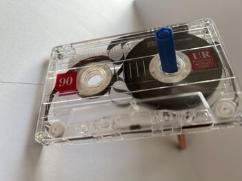 A tape with Sticky Shed Syndrome showing tape "squiggling" inside the case, instead of falling off in concentric rings.
